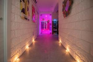 a hallway with lights on the walls at White Apartments & Spa in Avola