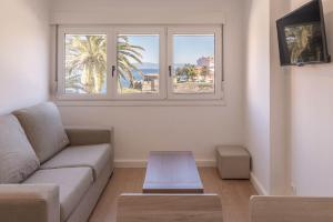 a living room with a couch and a window at Apartamento con vistas al mar en Fisterra in Fisterra