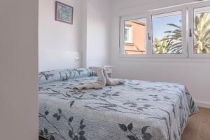 a bedroom with a bed with a stuffed animal on it at Apartamento con vistas al mar en Fisterra in Fisterra