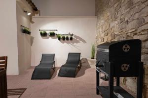 a room with a stove and two chairs at Ca la Cinta de Maldà in Maldá