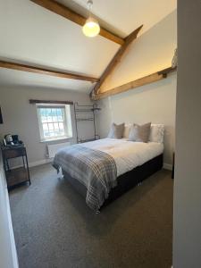 een slaapkamer met een bed en een raam bij The Tavern at Hale in Milnthorpe