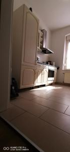 a kitchen with white cabinets and a tile floor at Monteurwohnung Krüger in Bitterfeld