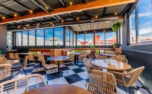 a restaurant with tables and chairs and windows at DWO Nopal in Puerto de la Cruz