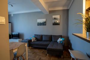 a living room with a couch and a table at Apartament Eliza in Warsaw