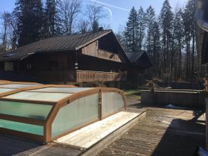 a wooden house with a fence in front of it at Room in Guest room - Mont Blanc room for 3 people with a balcony in Morillon