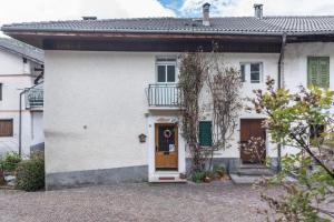 Biały dom z drzwiami i balkonem w obiekcie Casa Sicina Alberto w mieście Valfloriana