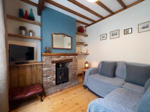 a living room with a couch and a fireplace at Host & Stay - Ethelbert Cottage in Broadstairs