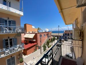 an apartment balcony with a view of a city at Avra Boutique in Benitses
