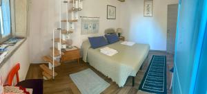 a bedroom with a bed with blue pillows at B&B Pascal House Nuoro_IUN E5016 in Nuoro