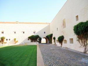 a courtyard of a building with a green lawn at Architect Arts Elegant Villa in Tavira