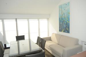 a living room with a couch and a table at The Roof On The Sea in Fondachello