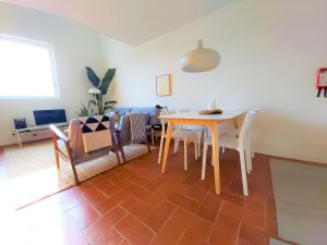a living room with a dining room table and chairs at Architect Arts Elegant Villa in Tavira