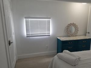 a bedroom with a blue dresser and a mirror at 1161 Studio 2 Main Miami in Miami