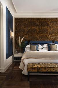 a bedroom with a king sized bed with a blue and gold wall at Vista Palazzo in Verona