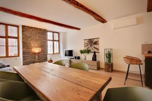 a living room with a wooden table and chairs at Le ST Tropez in Saint-Tropez