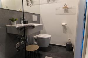 a small bathroom with a toilet and a sink at Arbio I Duxen Apartments Hagenbeck Zoo in Hamburg +6 photos