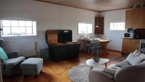a living room with a couch and a table at Knappagården in Glemminge
