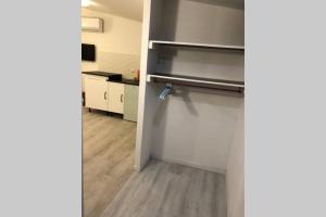 an empty room with a kitchen with a counter at Studio cosy avec possibilité piscine en supplément in Toulon