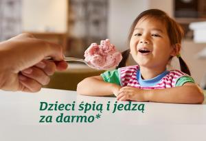 a little girl eating pink ice cream on a fork at Holiday Inn Krakow City Centre, an IHG Hotel in Krakow