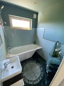 a bathroom with a sink and a bath tub at Vizbules in Turaida