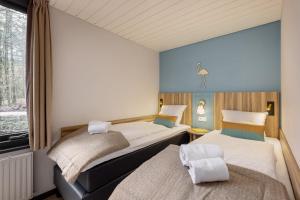 - 2 lits dans une petite chambre avec fenêtre dans l'établissement Center Parcs Heijderbos Limburg-Weeze, à Heijen