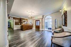 a large living room with wooden floors and a chandelier at Grosvenor Hotel in Stratford-upon-Avon
