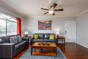 a living room with a couch and a ceiling fan at Villa Signature in Scottsdale