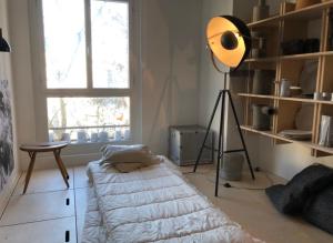 a room with a bed and a lamp in it at duplex top central Marais in Paris