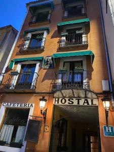 a building with a hospital sign on the side of it at Hostal Calderon Cuenca in Cuenca