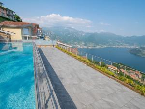 a swimming pool with a view of the water at Van Gogh - beautiful lake Iseo view and swimming pool in Parzanica