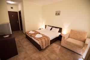 Postel nebo postele na pokoji v ubytování Family hotel Apolon