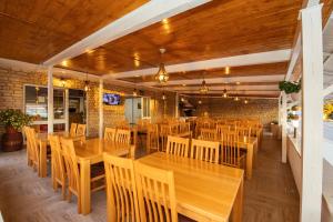 a dining room with wooden tables and chairs at Pansion Čirjak in Sveti Filip i Jakov