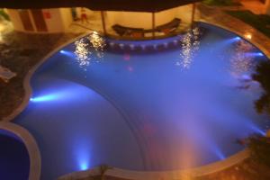a large swimming pool with blue lights on it at CostaSol Pipa Chalés in Pipa