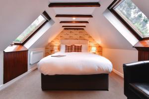 A bed or beds in a room at East Haugh House Hotel 
