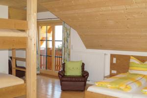 a living room with a bunk bed and a chair at Ferienhaus Hochfelner in Sankt Marein bei Knittelfeld