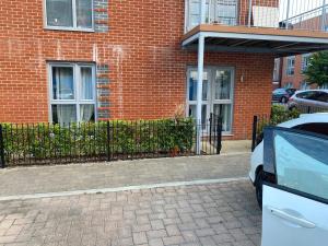 a brick building with a car parked in front of it at Ashs Apartments in Southampton