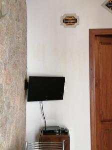 a flat screen tv hanging on a wall at Per Due in Porto Santo Stefano