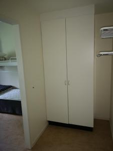 a room with two white cabinets and a bed at Åredalens fjällgård in Järpen