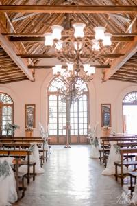 a wedding hall with tables and chairs and a chandelier at Kleinkaap Boutique Hotel in Centurion