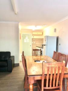 a kitchen with a table, chairs and a refrigerator at Bay Lodge in Denham
