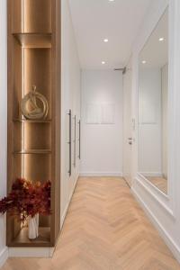 a hallway with white walls and a wooden floor at Plaza Apartments in Opatija