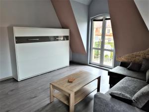 a living room with a couch and a coffee table at Yakuzza Apartments in Giżycko
