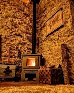a stone wall with a fireplace in a room at I Loft Viana in Viana do Castelo