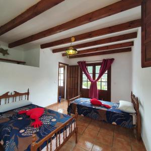 1 dormitorio con 2 camas y ventana en Casa del rio, en Málaga