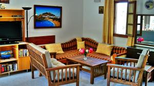 a living room with a couch and a table at Galini View Apartments Lindos in Lindos