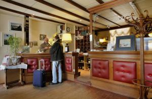 a person standing at a counter in a store at Le Normandy in Wissant