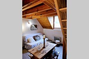 a living room with a couch and a table at Appartement T3 Saint Lary-Soulan; Vielle-Aure in Vielle-Aure