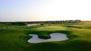 an aerial view of a golf course with a pond at Golf Villa in Lighthouse Golf & SPA Resort in Balchik