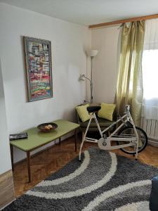 a living room with a bike and a table at Apartman Anđela in Varaždin