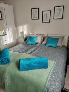 twee bedden met blauwe kussens in een slaapkamer bij Apartman Anđela in Varaždin